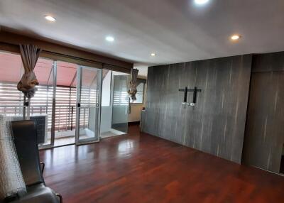 Modern living room with wooden flooring and glass doors