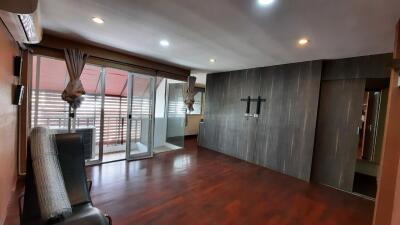 Modern living room with wooden flooring and glass doors