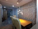 Well-lit dining area with elegant wallpaper and comfortable seating