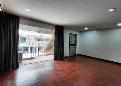 Spacious living room with large window and balcony access