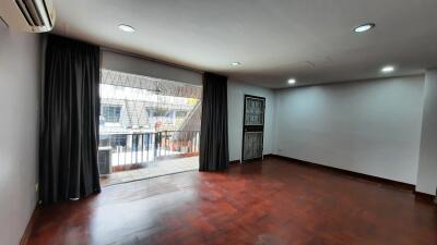 Spacious living room with large window and balcony access