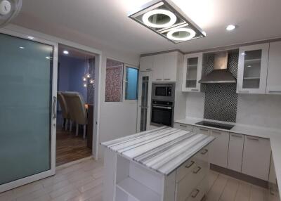 Modern kitchen with island and recessed lighting