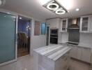 Modern kitchen with island and recessed lighting