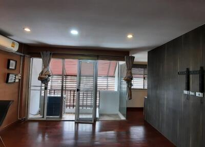 Modern living area with wooden flooring and glass doors