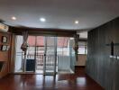 Modern living area with wooden flooring and glass doors