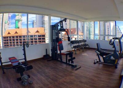 Modern gym with various fitness equipment and city view