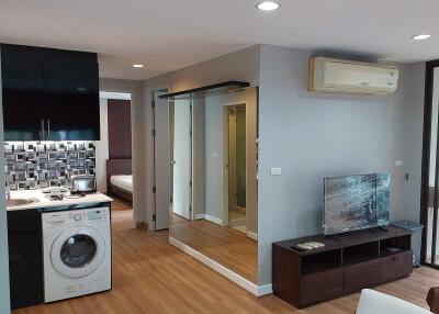 Modern living area with kitchen and laundry