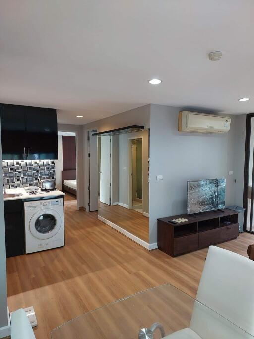 Modern living area with kitchen and laundry