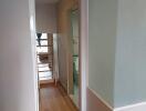 Corridor with wooden flooring and a frosted glass panel