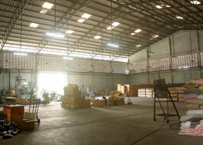 Spacious warehouse with high ceiling and storage areas