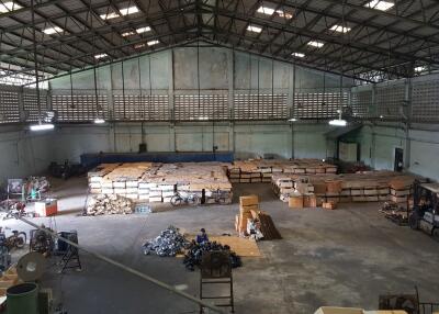 Spacious warehouse with stored goods and machinery