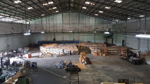 Spacious warehouse with stored goods and machinery