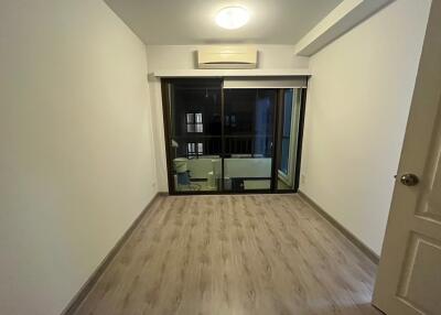 empty bedroom with wooden floor and sliding glass door