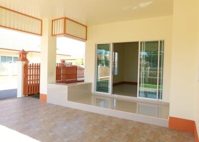 Front porch area with tiled flooring and sliding glass doors