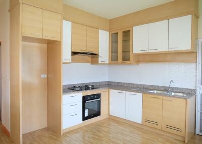 Modern kitchen with wooden cabinets and appliances