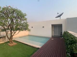 Rooftop pool area with wooden deck