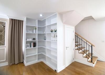 Modern living area with built-in shelves and staircase