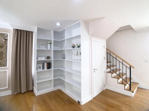 Modern living area with built-in shelves and staircase