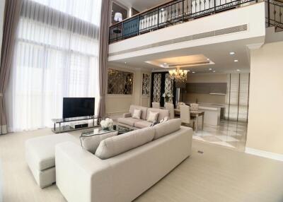 Spacious living room with high ceilings and modern furnishings