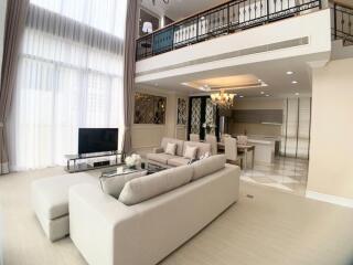 Spacious living room with high ceilings and modern furnishings