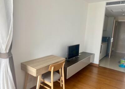 Main living space with desk and TV