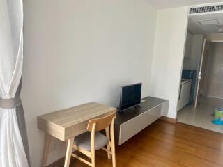 Main living space with desk and TV