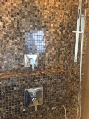 Modern bathroom with mosaic tile and sleek fixtures