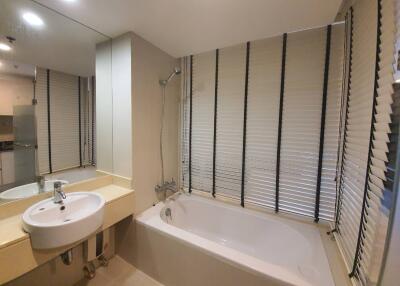 Modern bathroom with bathtub and blinds