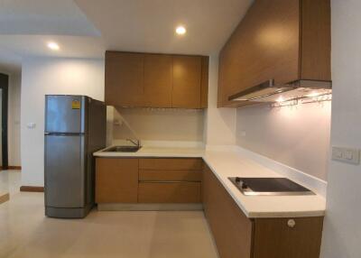 Modern kitchen with wooden cabinets and stainless steel appliances