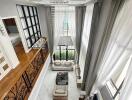 High ceiling living room with modern decor and mezzanine