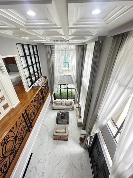 High ceiling living room with modern decor and mezzanine