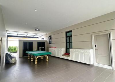 Spacious recreational room with pool table and cabinetry