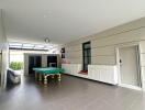 Spacious recreational room with pool table and cabinetry