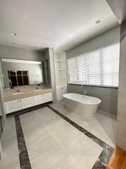 Spacious bathroom with a freestanding tub and double sink vanity