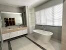 Spacious bathroom with a freestanding tub and double sink vanity