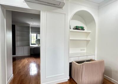 Main living space with hardwood floors and built-in shelves