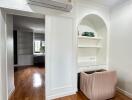 Main living space with hardwood floors and built-in shelves