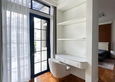 Cozy corner with built-in desk and shelves, adjacent to large window