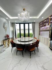 Elegant dining room with chandelier and round marble table