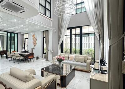 Spacious modern living room with high ceilings and large windows