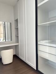 Modern bedroom with built-in wardrobe and vanity area