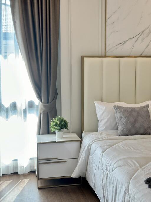 Modern bedroom with white bedding and nightstand