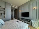 Modern bedroom with wall-mounted TV and built-in storage