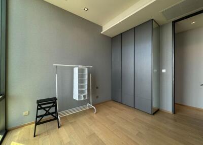 Minimalist bedroom with wooden flooring and wardrobe