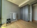 Minimalist bedroom with wooden flooring and wardrobe