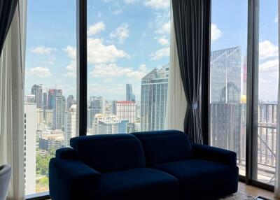 Modern living room with large glass windows and city view