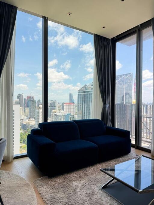 Modern living room with large glass windows and city view