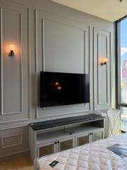 Bedroom with mounted TV and city view