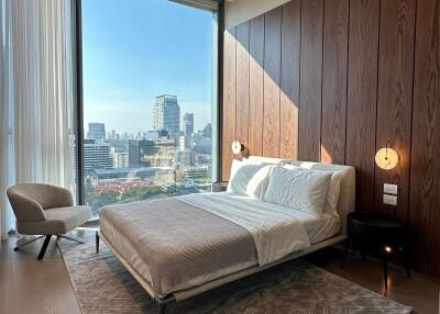 Modern bedroom with large window and city view