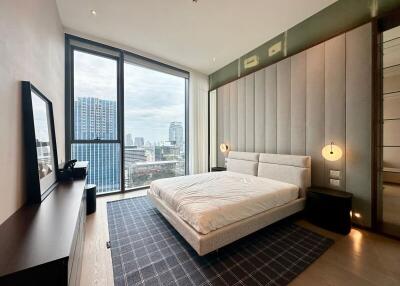 Modern bedroom with large window and city view